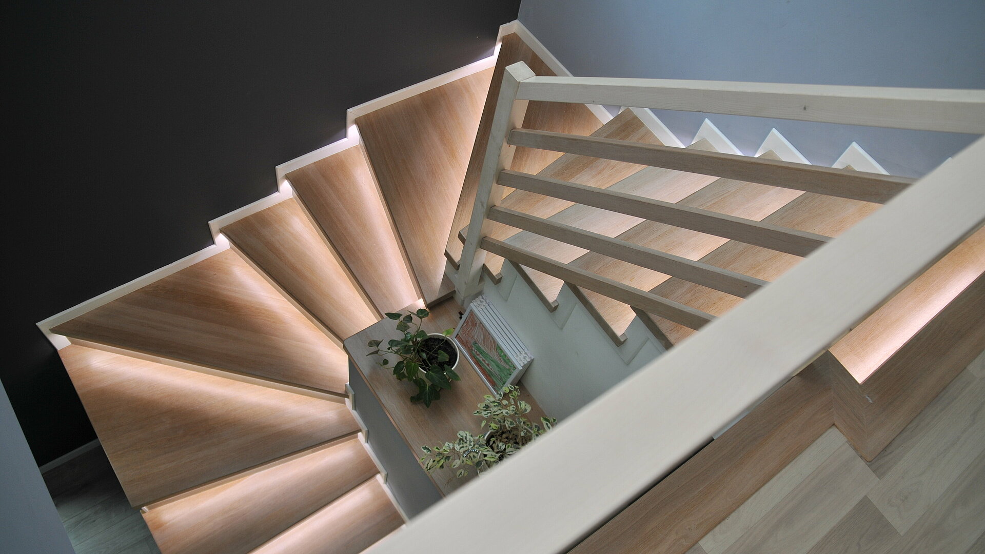 Aufnahme in Vogelperspektive einer Wendeltreppe mit Lichtinstallation an den Stufen